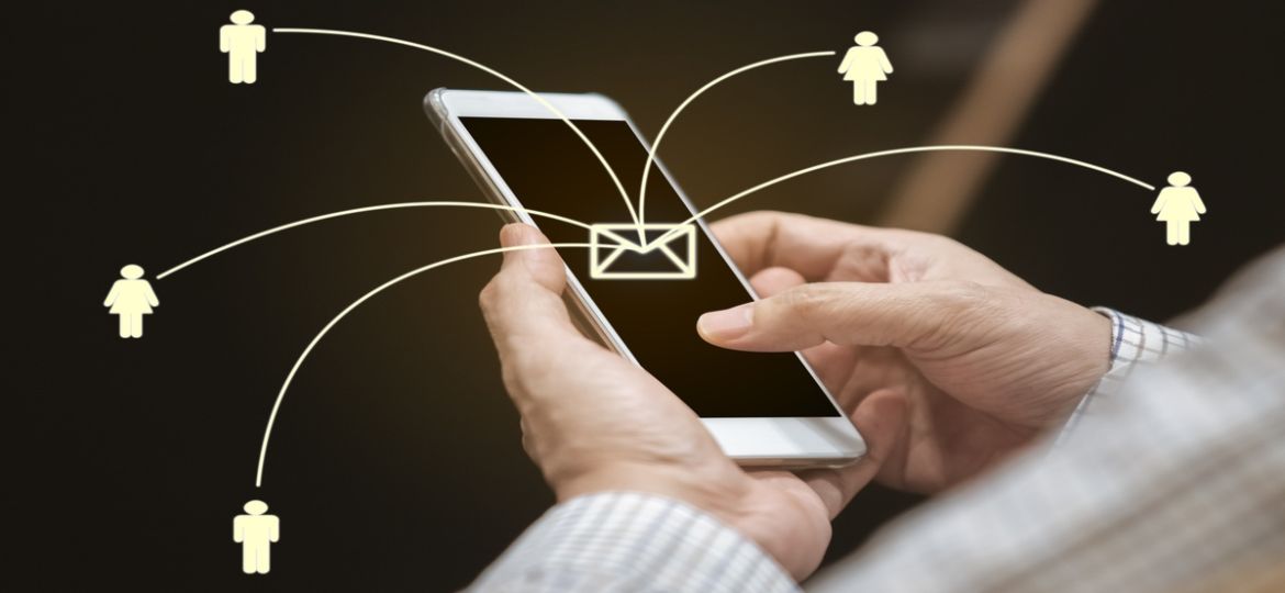 close up hand of man using smartphone sending message from E-mai